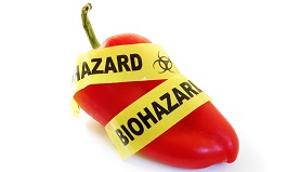 Red pepper with bio-hazard tape.food safety concept